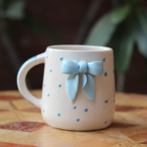 Cute white ceramic coffee mug with a 3D green bow detail