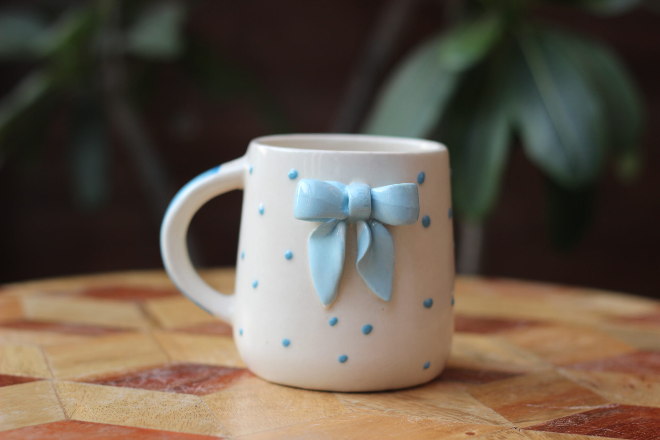 Cute white ceramic coffee mug with a 3D green bow detail